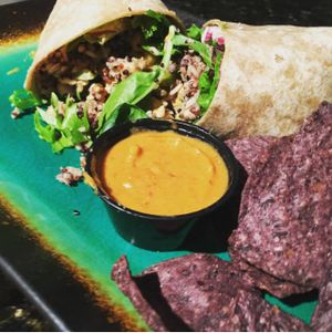 Takeaway DIY Wrap with queso & chips.  at Dandelion Community Cafe in Orlando