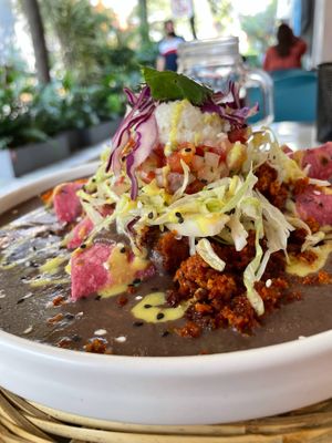 Enfrijoladas (filled with almond cheese and plátano) with vegan chorizo (made of chickpeas). at La Pitahaya Vegana in Mexico City