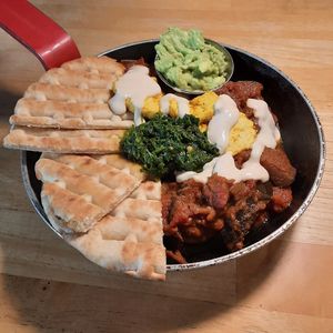 Aubergine and red pepper shakshuka with added avocado at Cafe Van Gogh in South West London