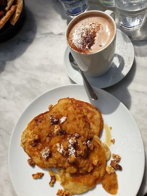 Oat pancakes with cinnamon apples and walnuts and hot chocolate at Cafe Van Gogh in South West London