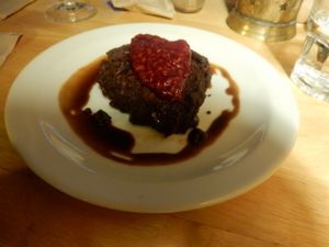 Brownie with raspberry coulis and oat cream. at Cafe Van Gogh in South West London