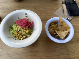 Guacamole 🥑 with pickled onions, toasted corn and cilantro sprouts 🌱   at Vegamo Centro in Mexico City