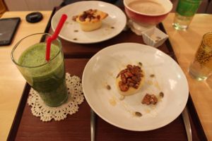 Cake with caramelised nuts and organic green smoothie of the day. at Babel Cafe in Osaka