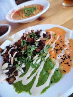 the 'red and green' variety of hummus with extra aubergine at The Hummus of Tahini in Jerusalem