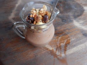 Amazing vegan chocolate mousse in a mug with cashew granola and coconut milk. To die for! at Plernpai Vegetarian Cafe in Mae Hong Son