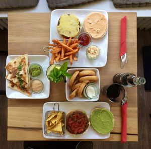 A full menu at the Blattgold. Tex-Mex Burger, OMG-Burger with extra cheese and sweetpotato fries, Quesadillas and Onion Rings. Coke and Homemade Lemonade. at Cafe Blattgold in Kiel