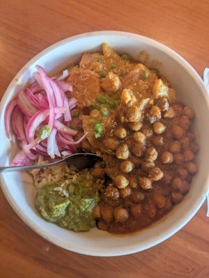 Coconut veggie korma & chana masala with pickled onions and hari mirch. at Masala in Missoula