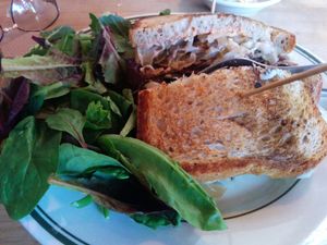 Delicious reuben sandwich with a side of greens at The Butcher's Son in Berkeley