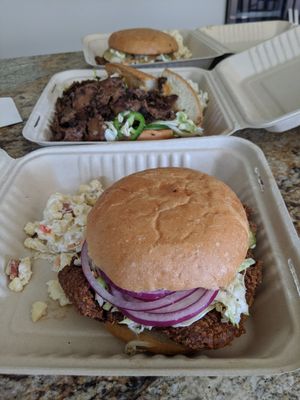 Front to back: fried chicken sandwich w/ bacon Mac salad, steak bahn mi with potato salad, and pulled pork with bacon Mac salad at The Butcher's Son in Berkeley