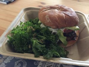 Mushroom onion tempeh burger with lemon kale salad at OM Foods in Chico
