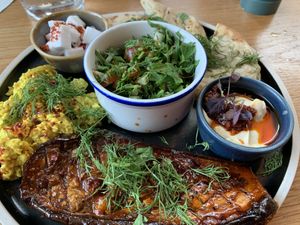 scrambled clean bean tofu, chopped salad, smoky grilled aubergine, vegan feta, hummus, apricot harissa, garlic pita at Mildreds - Kings Cross in North London
