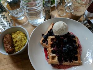 The quinoa oat and blueberry waffles with maple syrup and ice cream, "sausage," and scrambled tofu. at Mildreds - Kings Cross in North London