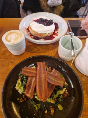 I had a chai latte, pea and avocado smash on focaccia with rashers added. My friend had the berry pancakes and a latte. (breakfast menu) at Mildreds - Kings Cross in North London