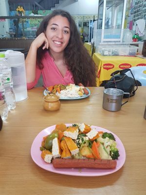 My lovely girlfriend and our piled plates at Hongming Vegetarian Food in Krabi