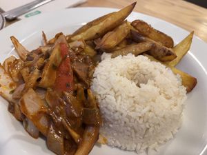 Sautéed mushrooms and vegetables with rice and chips.  at Seitan Urban Bistro in Lima