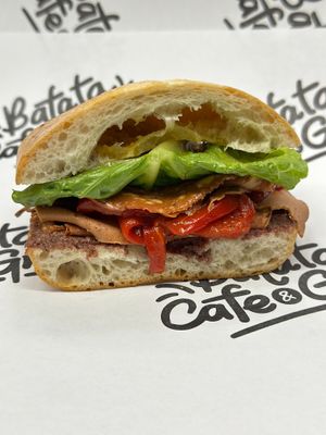 Prime Roots Muffaletta Sandwich w/Black Forest Koji Hame, Koji Salami, Roasted Red Peppers, Black Olive Tapenade, Lettuce & House Vinaigrette at Batata Cafe in Northport