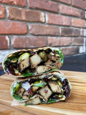 Grilled Seiten Wrap - Marinated Seiten, Roasted Brussels, Pepitas, Cranberries, Arugula & Shallot Aioli at Batata Cafe in Northport