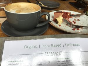 Almond milk vanilla latte and red velvet vegan cake. at Excalibur Cafe in Glastonbury