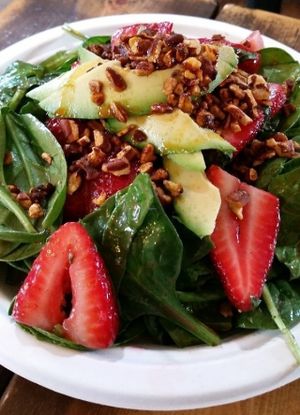 Balsamic spring greens salad with basil macerated strawberries, spicy candied pecans, and avocado. at A Broken Angel - Food Cart + Catering in Bend