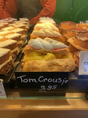 “Tompouce croissant hybrid”: chocolate croissant filled with pudding and topped with icing and cream. Often available on the weekends.  at Het Zaanse Bakkertje / Dutch Vegan Bakery in Zaandijk