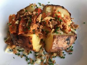 Vegan jack potato with vegan mayonnaise, vegan cheese, mock meat, herbs, baked onions & Granny's spicy sauce at Grannys Food in Rijswijk