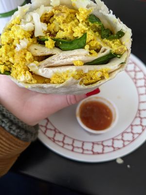 Tofu scramble breakfast burrito with hot sauce at Elemental Coffee in Oklahoma City