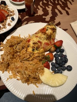 Hash browns, vegan omelette, and fresh fruit   at Disneyland - Storytellers Cafe in Anaheim