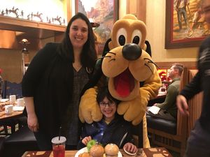Posing with Pluto at Disneyland - Storytellers Cafe in Anaheim