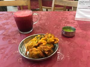Healthy Heart Juice and a side of Pakoras at Thenga Cafe in London