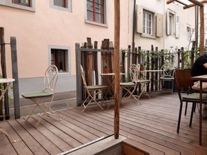 Outdoor seating in the back at Herzlich Anders Essen in Liestal