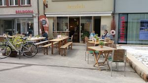Exterior with outdoor seating at Herzlich Anders Essen in Liestal