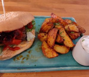 Spicy Tempeh Burger and Potato Wedges and Sour Cream at Zwei und Zwanzig in Geisenheim