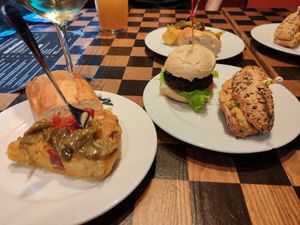 Pintxos: tortilla con pimientos, bocatín con humus y pico de gallo, mini hamburguesa de falafel. at K2 in Bilbao