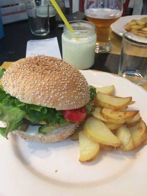 Chickpea and lentil burger with potato wedges at Dulcamara Bio Vegan Bistrot in Verona