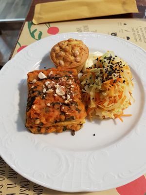 Savory muffin with cheackpeas, lentils lasagna and raw vegetables at Dulcamara Bio Vegan Bistrot in Verona