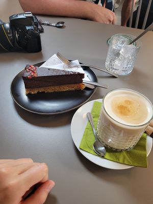Raw pomegranate cake and iced oat latte. at Vegan's Prague in Prague