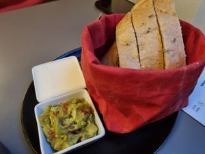 Fresh homemade bread with garlic and guacamole dips at Vegan's Prague in Prague