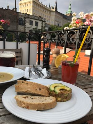 View on the Castle, avocado tartare, cauliflower soul, ice tea, beer at Vegan's Prague in Prague