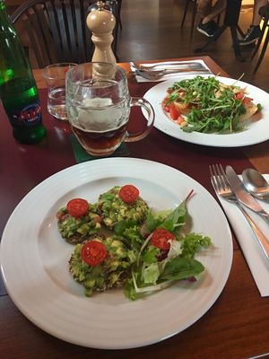 Guacamole with raw crackers appetizer...and the bruschetta from fresh tomatoes in the background. Oh and of course the beer;) at Vegan's Prague in Prague
