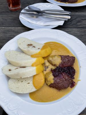 “Sirloin” with steamed yeasted dough dumplings, red berries, and root vegetable sauce   at Vegan's Prague in Prague