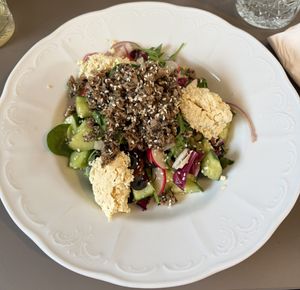 notuna salad with olives, cherry tomatoes, radish and our tofu feta!  at Vegan's Prague in Prague