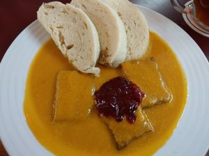 Tempeh with root veg sauce dumplings and cranberry jam at Vegan's Prague in Prague