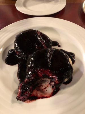 Sweet dumplings with a berry filling and sauce at Vegan's Prague in Prague