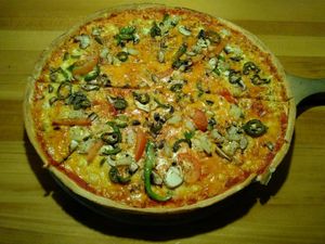 Thin-stretched, double-sized "Pride" pizza with vegan cheese and optional jalapeños for $22 at Hell Pizza in Queenstown