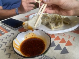 Dumplings with chilli sauce  at Jù Cái Sù Diàn in Tibet