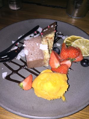 Raw delicious vegan chocolate cake with mango sorbet and dried fruits at Souls in Copenhagen