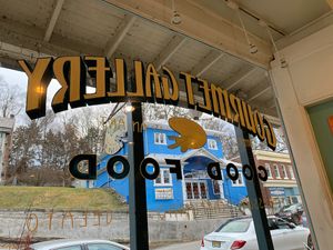 Front window sitting at cafe table?historic Roy’s Hall across the way  at Gourmet Gallery in Blairstown
