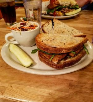 The Mast sandwich (vegan): marinated tofu, vegan walnuts basil pesto, spinach, and garlic veganaise on fresh rye bread (served with vegan coleslaw) at Crow's Nest in Kalamazoo