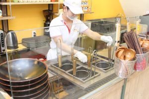 Employee preparing food at Healthy Farm - Tran Hung Dao District 1 in Ho Chi Minh City