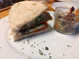 Half of my falafel waffle pita sandwich, with avacado slaw on the side. at Paisley Vegan Kitchen in Cocoa